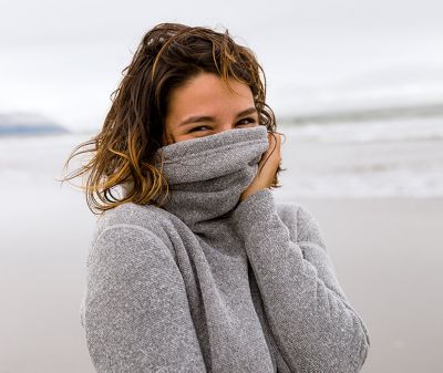 Smartwool model wearing sweater made with sustainable wool